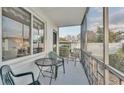 Cozy screened porch with small table and chairs at 1600 W Lake Parker Dr # B9, Lakeland, FL 33805