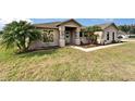 Inviting single-story home featuring lush landscaping, palm trees, and a cozy front porch at 1640 Taylor Landing Dr, Bartow, FL 33830