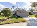 Charming single-story home featuring a well-manicured lawn and two-car garage at 1961 Rocky Pointe Dr, Lakeland, FL 33813