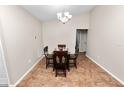 Dining room features tile floors and glass-top table with wooden chairs under a modern chandelier at 2160 Country Manor St, Bartow, FL 33830