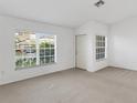 Bright living room with neutral carpet, white walls, and large windows offering plenty of natural light at 2454 Harrison Place Blvd, Lakeland, FL 33810