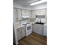 Bright kitchen features white cabinets, modern black sink and faucet, and updated appliances at 256 Village View Ln, Lakeland, FL 33809