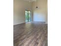Bright living room with hardwood floors, a ceiling fan, and sliding glass doors at 256 Village View Ln, Lakeland, FL 33809