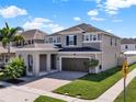 Charming two-story home featuring a brick driveway, a two-car garage, and well-maintained landscaping at 3460 Canvas St, Kissimmee, FL 34741