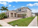 Charming two-story home featuring a brick driveway, a two-car garage, and well-maintained landscaping at 3460 Canvas St, Kissimmee, FL 34741