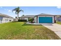 Well-maintained home with a lush lawn and blue garage door providing a welcoming curb appeal at 3719 Imperial Dr, Winter Haven, FL 33880
