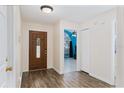 Inviting entryway with wood-look tile flooring and decorative front door at 403 Saint Anns Dr, Winter Haven, FL 33884