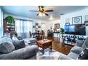 Cozy living room featuring hardwood floors, modern furniture, and large windows at 424 S Elm Rd, Lakeland, FL 33801