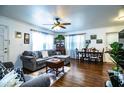 Spacious living room with hardwood floors, a ceiling fan, and natural light from the windows at 424 S Elm Rd, Lakeland, FL 33801