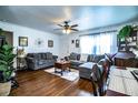 Open living room with hardwood floors, a ceiling fan, and a dining area set up at 424 S Elm Rd, Lakeland, FL 33801