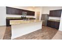 Modern kitchen featuring stainless steel appliances, granite countertops and a center island at 4932 St James St, Winter Haven, FL 33881