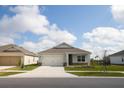 Beautiful single-story home with a two-car garage, complemented by a well-kept lawn and landscaping at 5062 Foxglove Cir, Lakeland, FL 33811
