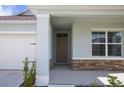 Welcoming front porch and entrance of home with stone veneer detail at 5062 Foxglove Cir, Lakeland, FL 33811