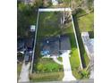 A top down view shows the home's position on an expansive lawn with a fenced perimeter at 515 Crevasse St, Lakeland, FL 33805