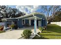 Newly renovated blue house with carport, landscaped yard, and white fence at 515 Crevasse St, Lakeland, FL 33805