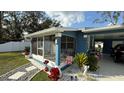 Charming blue house with screened porch and well-manicured landscaping at 515 Crevasse St, Lakeland, FL 33805