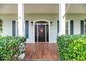 Charming front door with sidelights and a decorative heart, framed by lush greenery at 5155 Lake Deeson Woods Ct, Lakeland, FL 33805