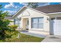 Inviting home exterior showcasing a manicured lawn, walkway and a quaint front entrance at 519 Eagle Ct, Kissimmee, FL 34759