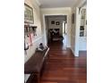 Inviting home hallway featuring hardwood floors, wainscoting, and a glimpse into other rooms at 528 Laurel Ln, Lakeland, FL 33813