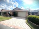 Charming single-story brick home with a well-manicured lawn and a neatly paved driveway at 600 Caribbean Dr, Lakeland, FL 33803