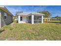 Charming new house with a spacious screened porch and a green lawn at 629 7Th W St, Lakeland, FL 33805