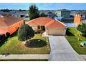 Inviting single-story home boasting a manicured lawn, neutral exterior, and an attached garage at 6610 Crescent Loop, Winter Haven, FL 33884