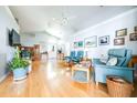 Bright living room featuring hardwood floors, neutral walls, and multiple seating options at 6962 Starmount Dr, Lakeland, FL 33810