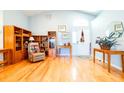 Open-concept living room with hardwood floors, neutral walls, and a decorative front door at 6962 Starmount Dr, Lakeland, FL 33810