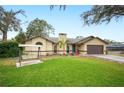 Well-maintained front lawn featuring an outdoor swing and charming home exterior at 7034 Morning Dove Cir, Lakeland, FL 33809