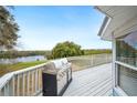 Spacious outdoor deck with stainless steel grill and views of the tranquil lake at 705 Lake Ada Blvd, Dundee, FL 33838
