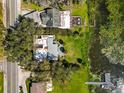 Aerial view of the house on a large lot with a dock on the lake at 14 Lake Hollingsworth Dr, Lakeland, FL 33803