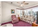 Bright living room featuring large windows, plush carpeting, and comfortable seating at 140 Jackson Park Ave, Davenport, FL 33897