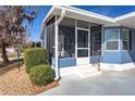 Enclosed screened porch area featuring blue siding and white trim at 140 Jackson Park Ave, Davenport, FL 33897