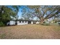 White brick home with a big shade tree in the front yard at 1632 Sims Pl, Lakeland, FL 33803