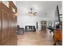 Open living room features neutral walls, tile floors, modern ceiling fan, and contemporary furniture at 1957 Prairie Dunes N Cir, Lakeland, FL 33810