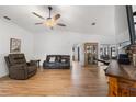 Bright living room features tile floors, modern ceiling fan, and contemporary leather furniture at 1957 Prairie Dunes N Cir, Lakeland, FL 33810