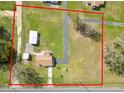 Aerial view showcasing the property's boundaries, outbuildings, and surrounding landscape at 2305 State Road 33 Hwy, Clermont, FL 34714