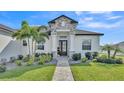 A close up of the entry to this beautiful home, featuring a stone accent entryway, and decorative landscaping at 2985 Pickards Pass, Lakeland, FL 33813