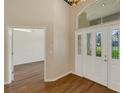 Bright foyer featuring hardwood floors and a white front door with leaded glass at 324 Lake Mariam Blvd, Winter Haven, FL 33884