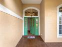 Inviting entrance with a green front door, transom window, and stylish tile landing at 324 Lake Mariam Blvd, Winter Haven, FL 33884