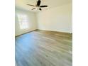 Bright bedroom featuring light gray floors, a ceiling fan, and a window letting in natural light at 3291 Alberta St, Bartow, FL 33830