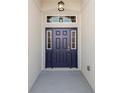 Elegant front door featuring sidelights, transom window, and a stylish exterior lantern at 3862 Willow Ridge Dr, Lakeland, FL 33810