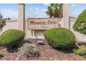 Meadow Oaks community entrance sign surrounded by lush green bushes and mulch at 3901 Oak Loop # 33, Mulberry, FL 33860