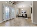 Inviting dining area featuring decorative glass front doors and a modern chandelier above the dining table at 4002 Sunset Lake Dr, Lakeland, FL 33810