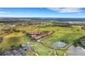 Aerial view of community featuring golf course, condominiums, and beautiful Florida landscape at 417 Enclave Pl # 2, Lakeland, FL 33803