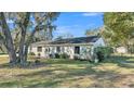 Single-story home with white trim, a well-maintained lawn, and mature trees at 4601 Sw Reynosa Sw Dr, Winter Haven, FL 33880