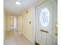 Bright foyer features tiled floor, a decorative front door, and neutral paint at 474 Cameo Dr, Lakeland, FL 33803