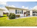 Inviting home exterior with lush lawn, attractive landscaping, and a convenient carport at 474 Cameo Dr, Lakeland, FL 33803