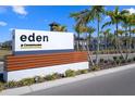 Eden at Cross Prairie community sign surrounded by palm trees and lush landscaping at 5002 Rain Shadow Dr, St Cloud, FL 34772