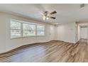 Bright living room featuring wood floors, a ceiling fan, and large bay window allowing natural light at 5908 Lunn Rd, Lakeland, FL 33811